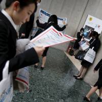 Women visit a job fair in Tokyo on March 20. A law requiring firms to promote female staff took effect Friday. | REUTERS