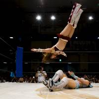 Io Shirai (top) performs a moonsault onto Mayu Iwatani during their Stardom professional wrestling show at Korakuen Hall in Tokyo in July 2015. | REUTERS