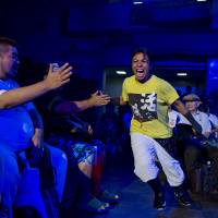 Stardom wrestler Kris Wolf greets fans as she enters the arena. | REUTERS