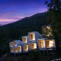 Guests stay in minimal concrete “cabins” with large windows that look out to Mount Fuji and the waters of Lake Kawaguchi. Minimalist family 'camping' in the foothills of Mount Fuji