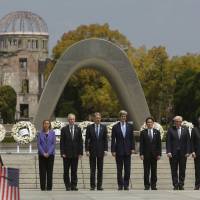 Needed gesture: G-7 foreign ministers stand together after placing wreaths at the cenotaph at Hiroshima Peace Memorial Park and Museum in Hiroshima. There’s a chance that U.S. President Barack Obama will follow suit. Obama has unfinished business in Hiroshima