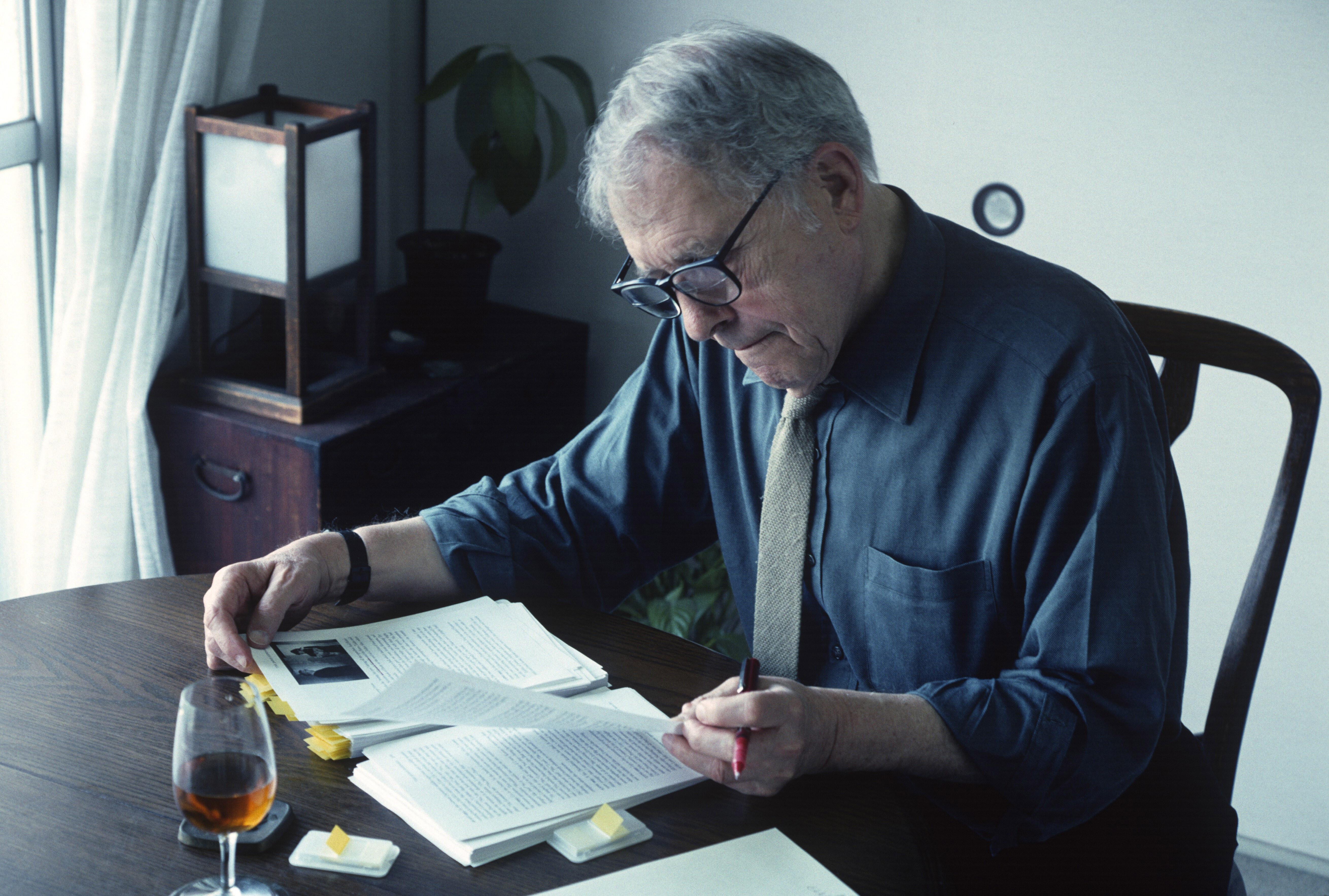 Embedded reflections: Donald Richie in 2004, in his home beside Tokyo's Ueno Park, overseeing the manuscript of his book 'The Japan Journals: 1947-2004.' | STEPHEN MANSFIELD