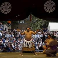 Yokozuna Hakuho performs a traditional ring-entering rite, called dohyo-iri. | REUTERS