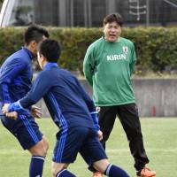 Japan Under-23 manager Makoto Teguramori puts his players through their paces at a training camp in Shizuoka Prefecture on Monday. | KYODO