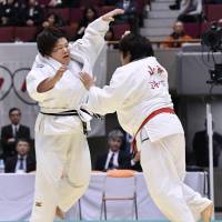 Megumi Tachimoto (left) and Kanae Yamabe compete in the final of the national judo championships in Yokohama on Sunday. | KYODO