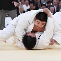 Takeshi Ojitani defeats Daiki Kamikawa at the open-weight National Judo Championship on Friday. | KYODO
