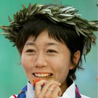 Marathon runner Mizuki Noguchi is seen with her gold medal at the 2004 Athens Olympics. | KYODO