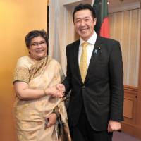 Bangladesh Ambassador Rabab Fatima (left) welcomes Parliamentary Vice-Minister for Foreign Affairs Hitoshi Kikawada (right) during a reception to celebrate of the country\'s the 45th Anniversary of Independence and National Day at Hotel Okura, Tokyo on March 29. | YOSHIAKI MIURA