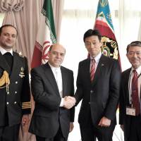 Iranian Ambassador Reza Nazarahari (second from left) shakes hands with Lower House member Yasutoshi Nishimura. They are flanked by Iranian Military Attache to Japan Capt. Farrokh Movaghar Hassani (left) and Special Adviser to the Minister of Defense Shigeru Iwasaki during a reception to celebrate \"Iran\'s Armed Forces Day\" at the embassy in Tokyo on April 15. | YOSHIAKI MIURA