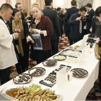 People attend a tourism seminar at the Japanese Embassy in London on Monday, ahead of the Ise-Shima Group of Seven summit in May. Specialties from Mie Prefecture were served to the 80 people who attended. | KYODO
