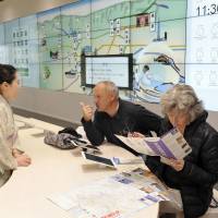 A pair of Canadian tourists get help from the information center at Tokyo\'s Shinjuku Expressway Bus Terminal, which opened Monday. The new transportation hub consolidates 19 separate bus stations and will service about 40,000 daily long-distance bus passengers traveling to 39 of the nation\'s 47 prefectures. | YOSHIAKI MIURA