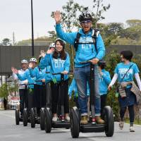 People ride Segways during a demonstration tour in Futako-Tamagawa, in Tokyo\'s Setagaya Ward, on Tuesday. The popular vehicles were all but banned on public roads until restrictions were eased last year. A regular driver\'s license is needed to drive them, and tour organizers hope to open services to the public in summer. | SATOKO KAWASAKI