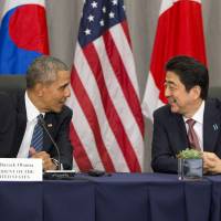 U.S. President Barack Obama speaks with Prime Minister Shinzo Abe during their meeting at the Nuclear Security Summit in Washington on March 31, 2016. Obama will travel to Hiroshima in May 2016 in the first visit by a sitting American president to the site where the U.S. dropped an atomic bomb.  | AP