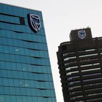 The logo of South Africa\'s Standard Bank is seen above the company\'s headquarters in Cape Town, South Africa, on May 6. | REUTERS