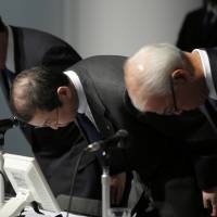 Takata Corp. executives bow in apology in June over the scandal caused by faulty air bags. | BLOOMBERG