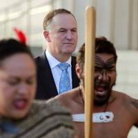 New Zealand Prime Minster John Key looks on as Maori performers greet French Prime Minister Manuel Valls in Auckland on May 2. | AFP-JIJI