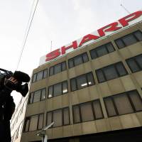 Sharp\'s headquarters building in Osaka is seen in this file photo. The firm plans to sell the current headquarters and will likely move to the city of Sakai, which is also in Osaka Prefecture. | KYODO