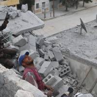 Civil defense members work at a site hit by an airstrike in the rebel held area of Aleppo\'s Baedeen district, Syria, Tuesday. | REUTERS