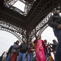 Tourists line up at the Eiffel Tower on Monday. Eiffel Tower to host four residents during soccer tournament