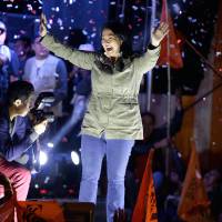 Presidential candidate Keiko Fujimori greets supporters as she campaigns during her birthday, in the San Martin shantytown on the outskirts of Lima, Peru, Wednesday. The South American country is gearing up for a tight June 5th runoff between Fujimori, the daughter of jailed former President Alberto Fujimori, and former World Bank economist Pedro Kuczynski. | AP