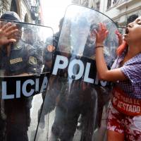 Activists protest Peruvian presidential candidate Keiko Fujimori outside the presidential palace in Lima Thursday. | REUTERS