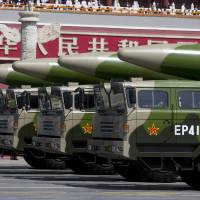 Chinese military vehicles carrying DF-26 ballistic missiles drive past Tiananmen Gate during a military parade to commemorate the 70th anniversary of the end of World War II, in Beijing last September. | AP