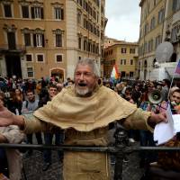 A man dressed as a friar demonstrates against same-sex civil unions outside the Italian Parliament in Rome on Wednesday. Italy’s parliament gave a green light for the introduction of gay civil unions in the last major Western country not to legally recognize same-sex relationships. Italy last in EU to grant rights to gay couples but balks on adoptions, nuptials