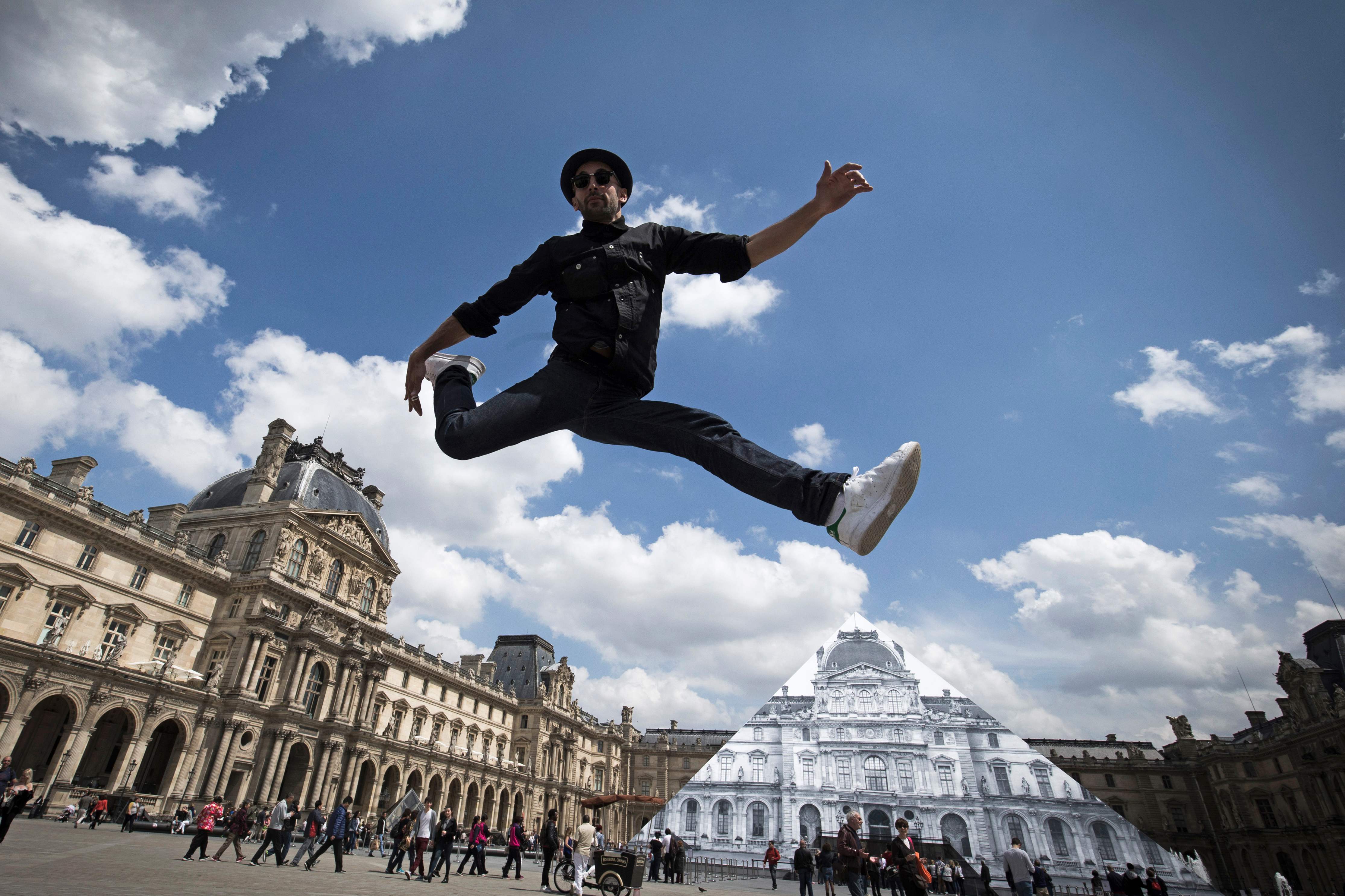 Louvre Pyramid vanishes in French street artist's optical illusion ...