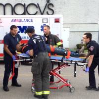 The suspect in a series of stabbings is transported on a gurney into an ambulance by medical personnel at the Silver City Galleria mall in Taunton, Massachusetts, Tuesday. Multiple people have been stabbed in separate attacks at the mall and a home in Massachusetts. | CHARLES WINOKOOR / THE DAILY GAZETTE VIA AP