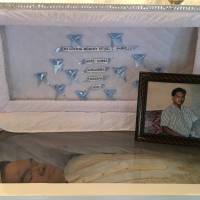 Gil Gabrillo, 47, lies in an open coffin at his house on May 16 after he was shot dead by motorbike-riding gunmen in Davao, the Philippines. | REUTERS