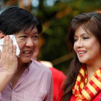 Philippine vice presidential candidate Bongbong Marcos talks to his sister, Ilocos Norte Gov. Imee Marcos, in this October file image. Bongbong Marcos leads family's revival in the Philippines