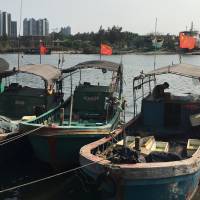 Fishing boats with Chinese national flags are seen at a harbor in Tanmen, Hainan province, on April 5. | REUTERS