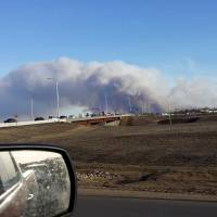 Vehicles are seen on highway 63 as they are detoured near a wildfire burning near Fort McMurray, Alberta, Sunday. The uncontrolled wildfire burning near Fort McMurray in northern Alberta, the heart of Canada\'s oil sands region, has forced the evacuation of nearly all the city\'s 80,000 residents, local authorities said Tuesday. | COURTESY GREGORY HONG / HANDOUT VIA REUTERS