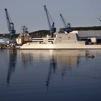 Early morning sun shines Thursday on the Zumwalt at Bath Iron Works in Bath, Maine. The shipyard will soon hand over the largest missile destroyer to the Navy. With Capt. James Kirk in command, U.S. Navy set to take ownership of largest destroyer