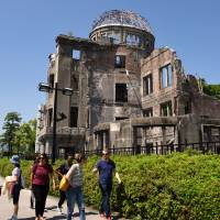 Visitors walk in front of the Hiroshima Peace Memorial in Hiroshima on May 17. | SATOKO KAWASAKI