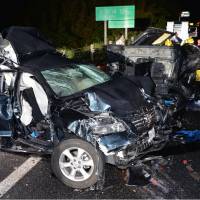 Two wrecked vehicles are seen on the Sanyo Expressway in Yamaguchi Prefecture after a seven-car pileup killed three people on Tuesday night. | KYODO