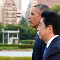 U.S. President Barack Obama and Prime Minister Shinzo Abe walk toward the Atomic Bomb Dome after laying wreaths at Hiroshima Peace Memorial Park last Friday. | AFP-JIJI