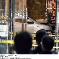 A car sits partially inside the O.T.K. Building near Kinshicho Station in Sumida Ward, Tokyo, on Sunday. | KYODO