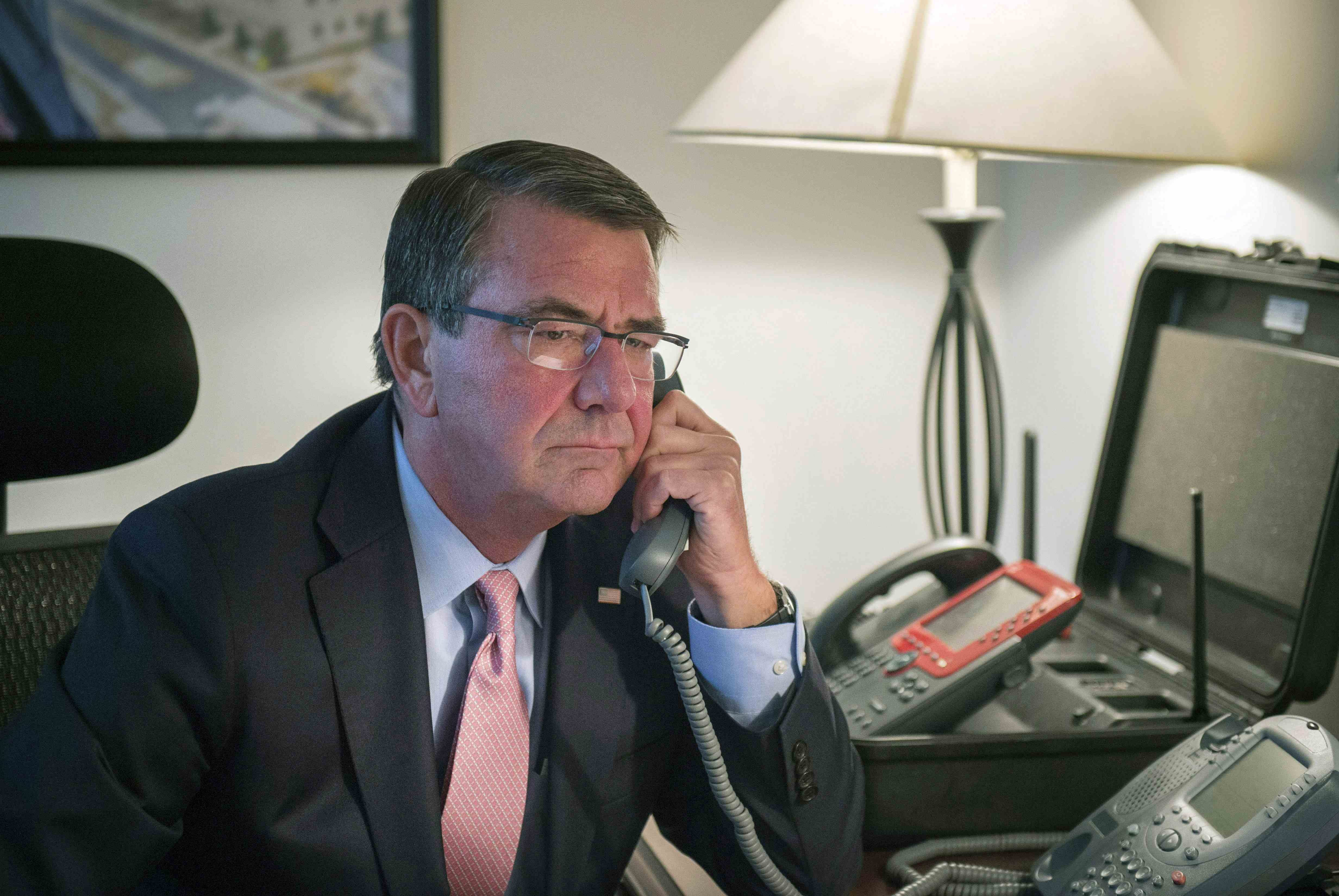 U.S. Secretary of Defense Ash Carter speaks on the telephone with Japanese Defense Minister Gen Nakatani in this photo released by the U.S. Department of Defense on Saturday. | REUTERS