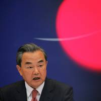 Chinese Foreign Minister Wang Yi addresses reporters in Beijing on Thursday. | REUTERS