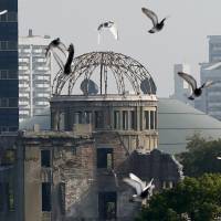 Doves fly over the atomic bomb dome in Hiroshima. A majority of people interviewed in the streets of Tokyo on Wednesday said U.S. President Barack Obama does not need to say sorry during his May 27 visit to Hiroshima. | REUTERS