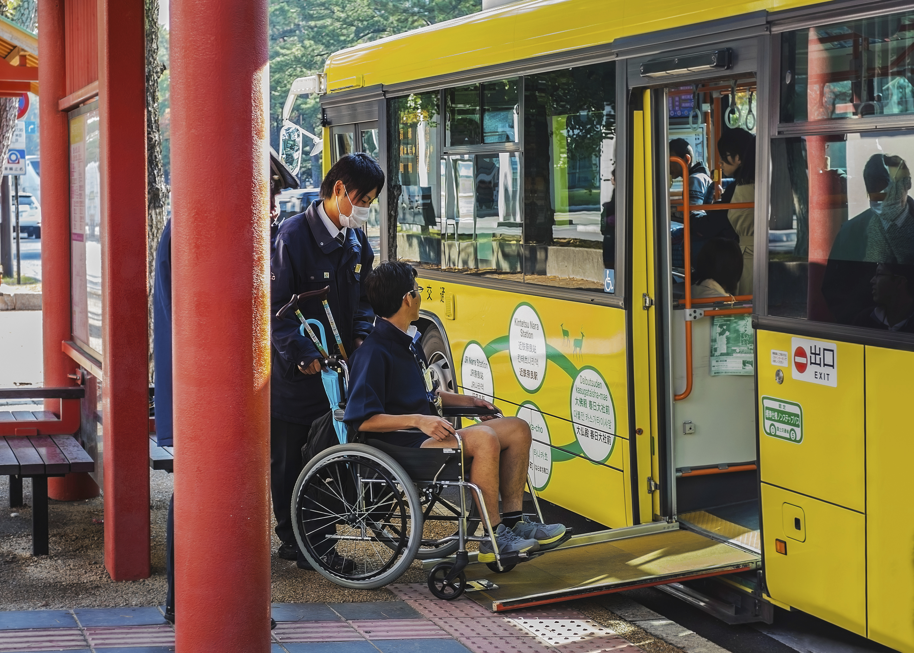 A man in a wheelchair rides a loop bus in Nara Prefecture. A new law requires government agencies and private businesses to remove 'social barriers' for people with impairments, including ensuring their access to public transportation. | ISTOCK