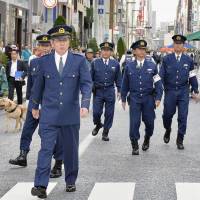 Kiyotaka Takahashi (front), superintendent-general of the Metropolitan Police Department, patrols Tokyo\'s swanky Ginza shopping district Saturday to inspect security ahead of the Group of Seven summit starting Thursday in Shima, Mie Prefecture. | KYODO