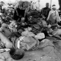 In a photo taken by Yotsugi Kawahara on Aug. 9, 1945, victims of the Aug. 6 atomic bombing seek treatment at an emergency relief station next to the Otagawa River. | REUTERS
