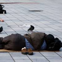 Homeless and unemployed people sleep in the Kabukicho district in Tokyo. While Tokyo counts fewer homeless in daytime, advocacy group finds higher numbers at night