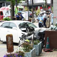 Seven people were injured, two seriously, after a car (pictured) rammed into pedestrians in Kobe\'s Sannomiya area on Tuesday morning. | KYODO