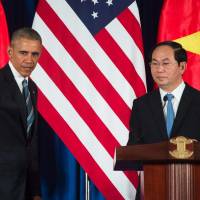 U.S. President Barack Obama and Vietnam President Tran Dai Quang take part in a joint news conference in Hanoi on Monday. | AFP-JIJI