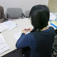 A female nursing care worker who said she has depression due to overwork applies for workers\' compensation in March. | KYODO
