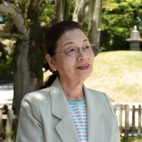 Hibakusha Tamiko Shiraishi speaks in front of the atomic bomb memorial tower, which houses the unclaimed remains of more than 70,000 people, in Hiroshima on May 18. | SATOKO KAWASAKI