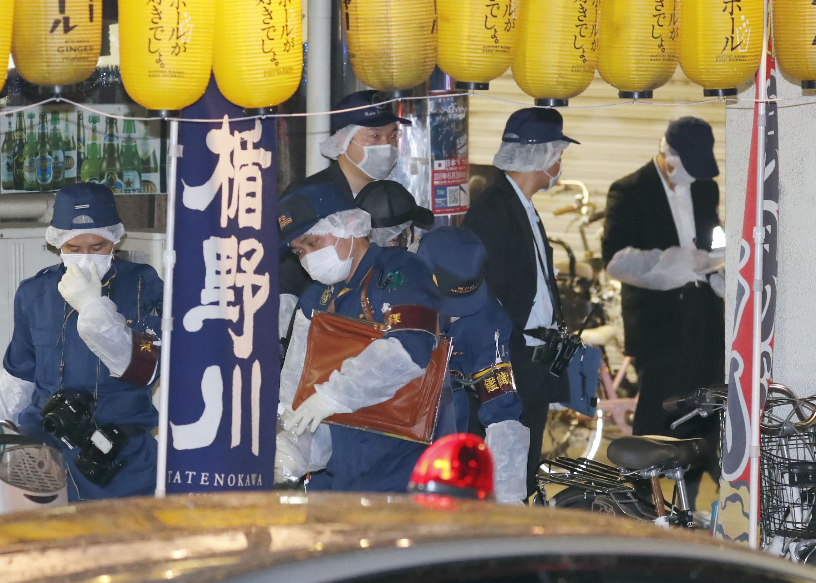 Police investigate the scene of the stabbing of female idol Mayu Tomita in the city of Koganei, Tokyo, on Saturday. | KYODO